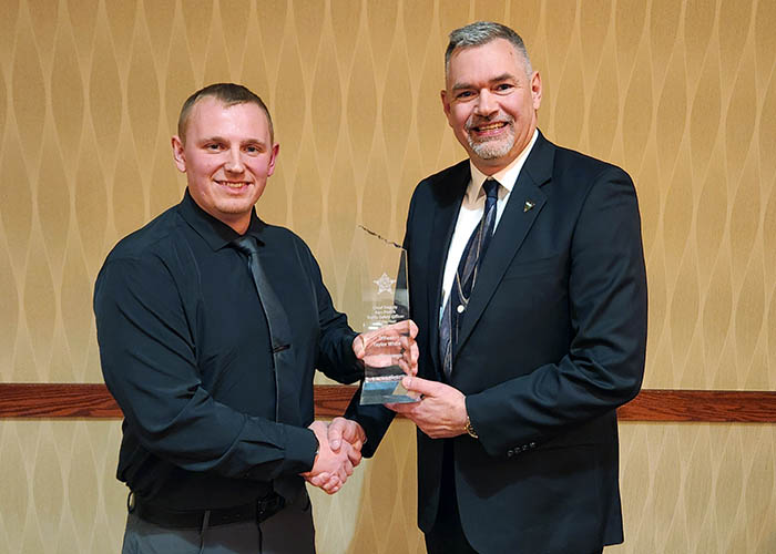Officer Taylor White receives award from Rob Weinmeister, Office of Highway Safety